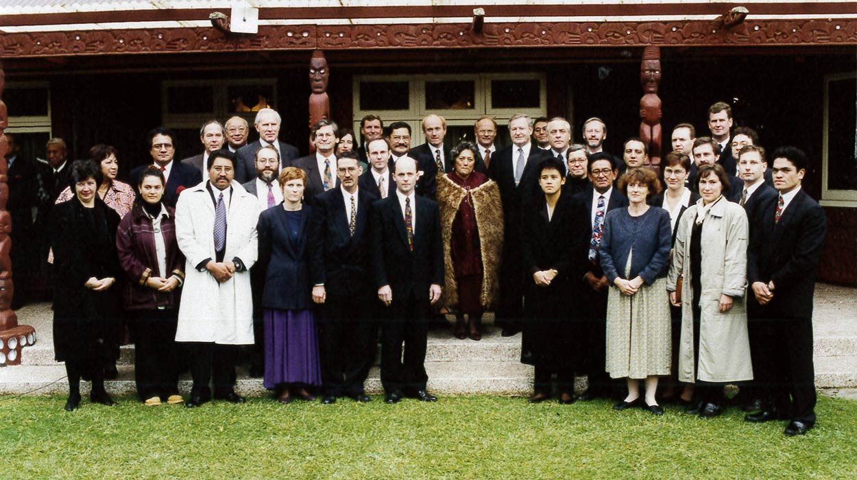 Dame Te Atairangikaahu at the centre of a group of people.